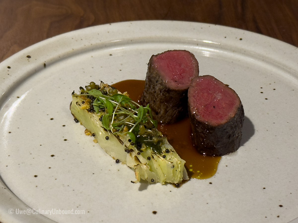 Taunus deer grilled over coniferous wood with pointed cabbage, parsley, and wild garlic fruits